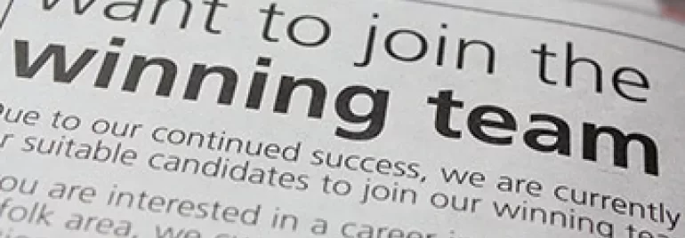 Close-up of a newspaper ad with the text 'want to join the winning team'.