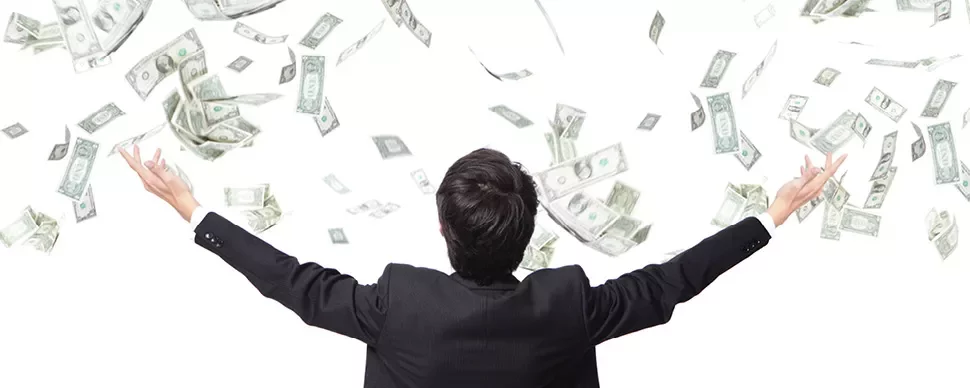 Man in suit with arms raised as money falls around him.