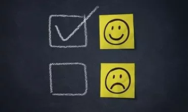 Checked box with smiley face, unchecked box with sad face.